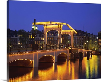 Magere Bridge illuminated in the evening, Amsterdam, Holland (The Netherlands)