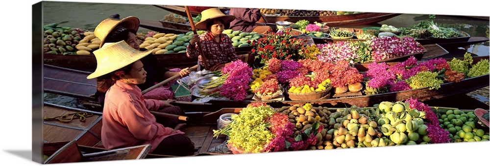 Market traders in boats laden with fruit and flowers, Bangkok, Thailand