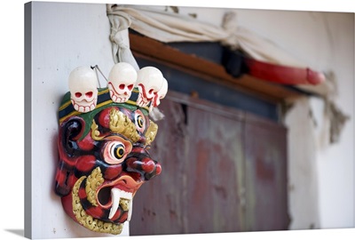 Mask and phallus hanging on a door to protect its occupants, Metshina, Punakha, Bhutan