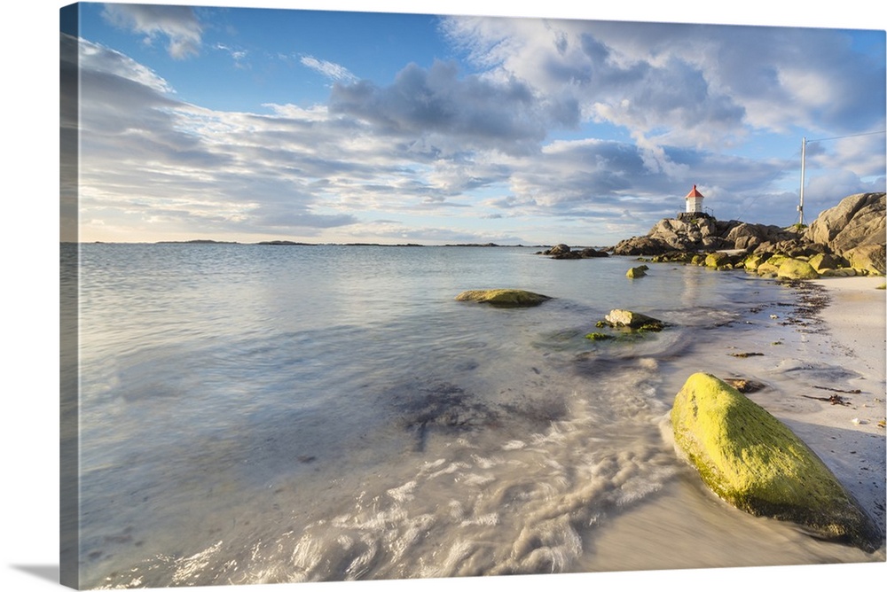 Midnight sun lights up cliffs and sandy beach surrounded by turquoise sea, Eggum, Unstad, Vestvagoy, Lofoten Islands, Norw...