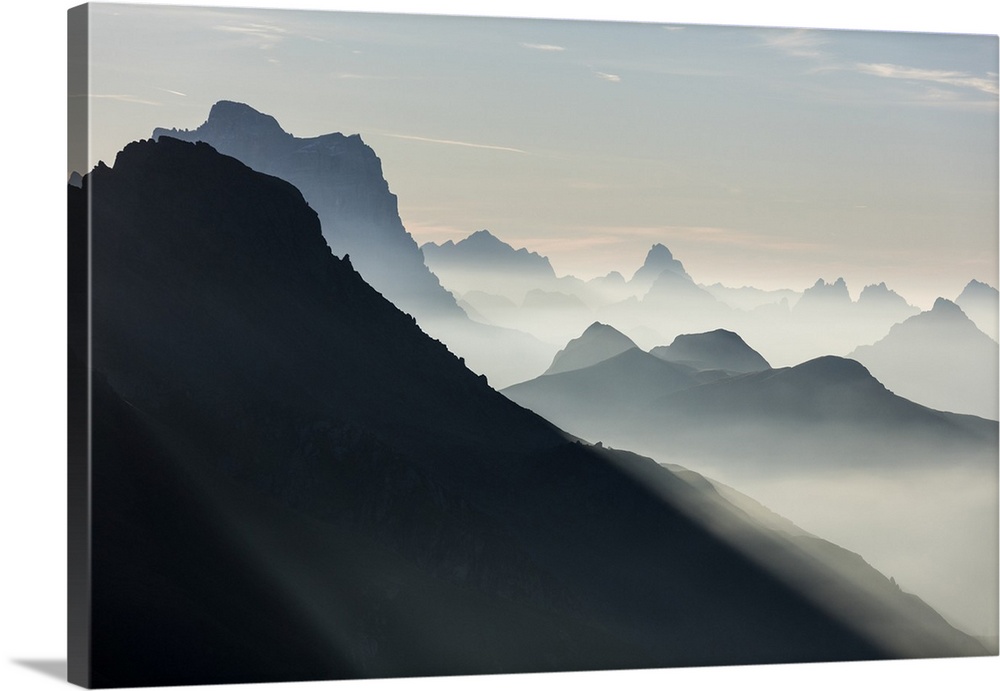 Mist on peaks of Dolomites and Monte Pelmo seen from Cima Belvedere at dawn, Val di Fassa, Trentino-Alto Adige, Italy, Europe