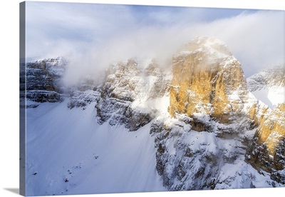 Mist Over The Rocky Peaks During A Snowy Winter, Gardena Pass, Dolomites, Italy