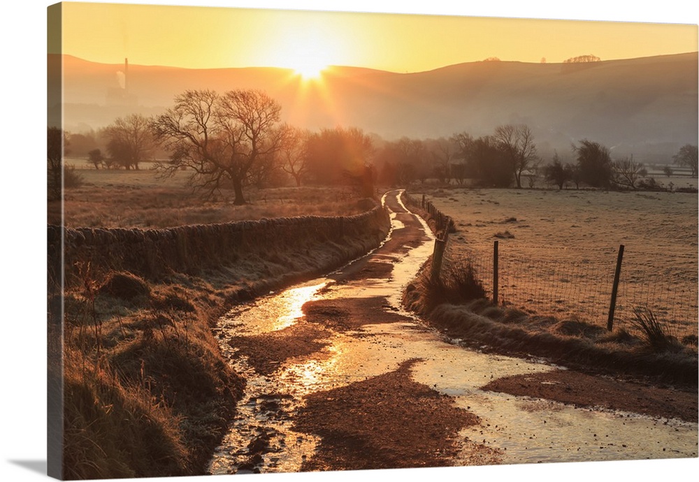 Misty and frosty sunrise over a country lane in winter, Castleton, Peak District National Park, Hope Valley, Derbyshire, E...