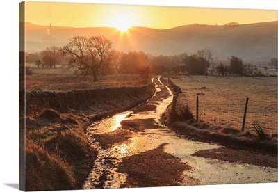 Misty and frosty sunrise over a country lane, Peak District National Park, England