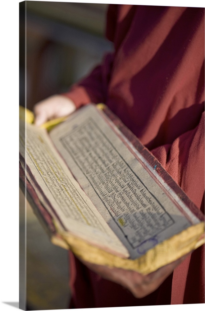Monk holding Buddhist prayer book, Rumtek Gompa, Gangtok, Sikkim, India, Asia