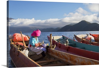 Mosu woman on boat, Luoshui, Lugu Lake, Yunnan, China
