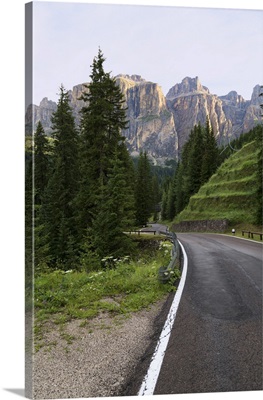 Mountain road and the Sassolungo mountains in the Dolomites, Italy