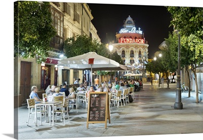 Night view of cafes along Calle Lanceria and El Gallo Azul rotunda building, Spain