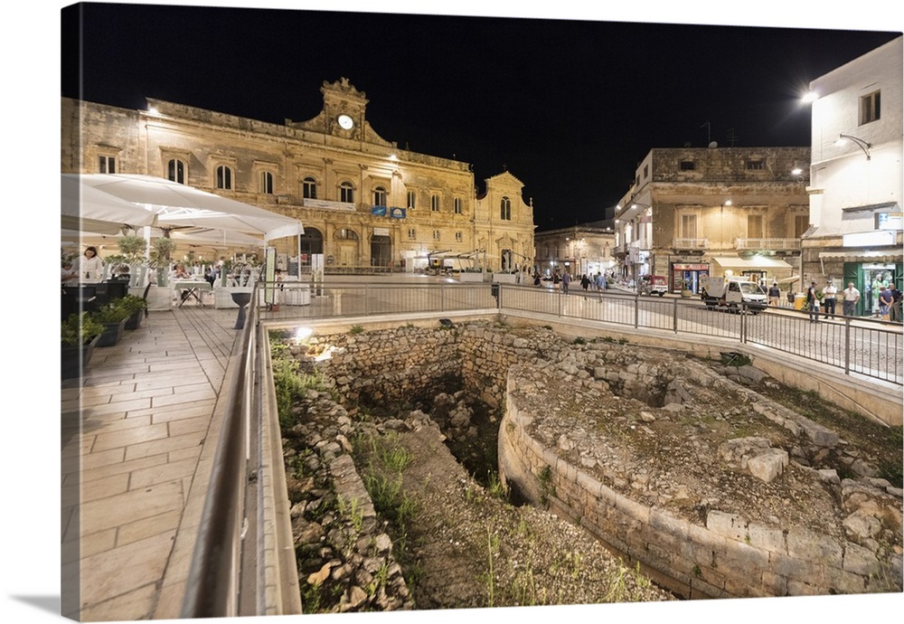 Night view of the Town Hall and ancient ruins in the medieval old town of Ostuni, Province of Brindisi, Apulia, Italy