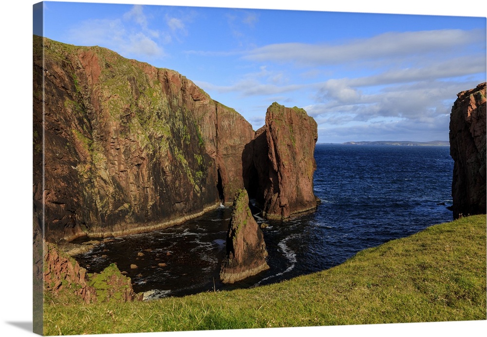 North Ham, lichen covered huge red granite cliffs and stacks, Muckle Roe Island, Shetland Isles, Scotland, United Kingdom,...