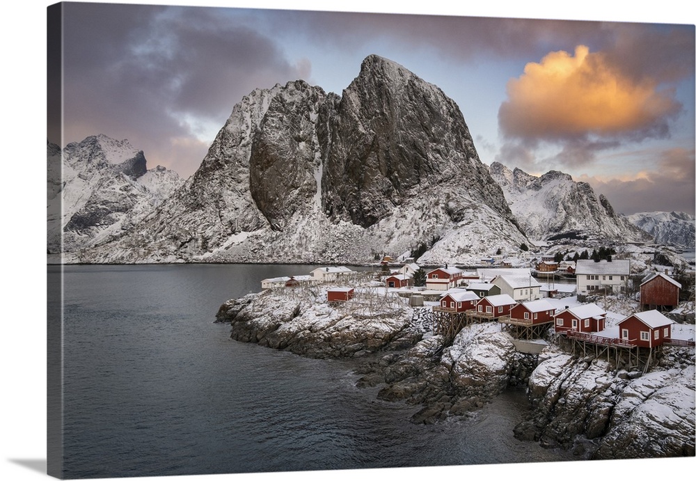 Red Norwegian Rorbuer Huts and Festhaeltinden mountain in winter, Hamnoy, Moskenes Municipality, Nordland County, Lofoten ...