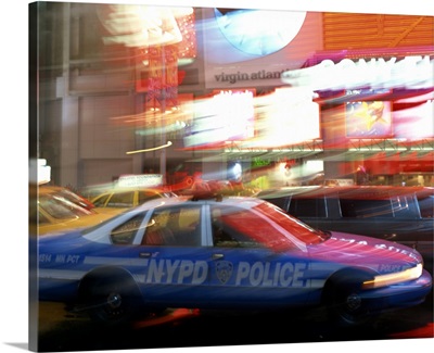 NYPD police car speeding through Times Square, New York City, New York