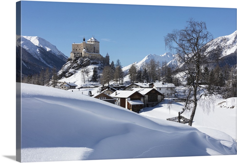 Old castle and alpine village of Tarasp surrounded by snowy peaks, Inn district, Canton of Graubunden, Engadine, Switzerla...