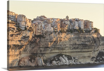 Old citadel townhouses and church at dawn seen from the sea, Bonifacio, Corsica, France