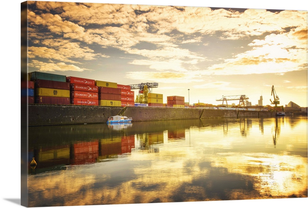 One of Main River's side channels with stacked containers and golden reflections in an industrial setting, Frankfurt, Hess...