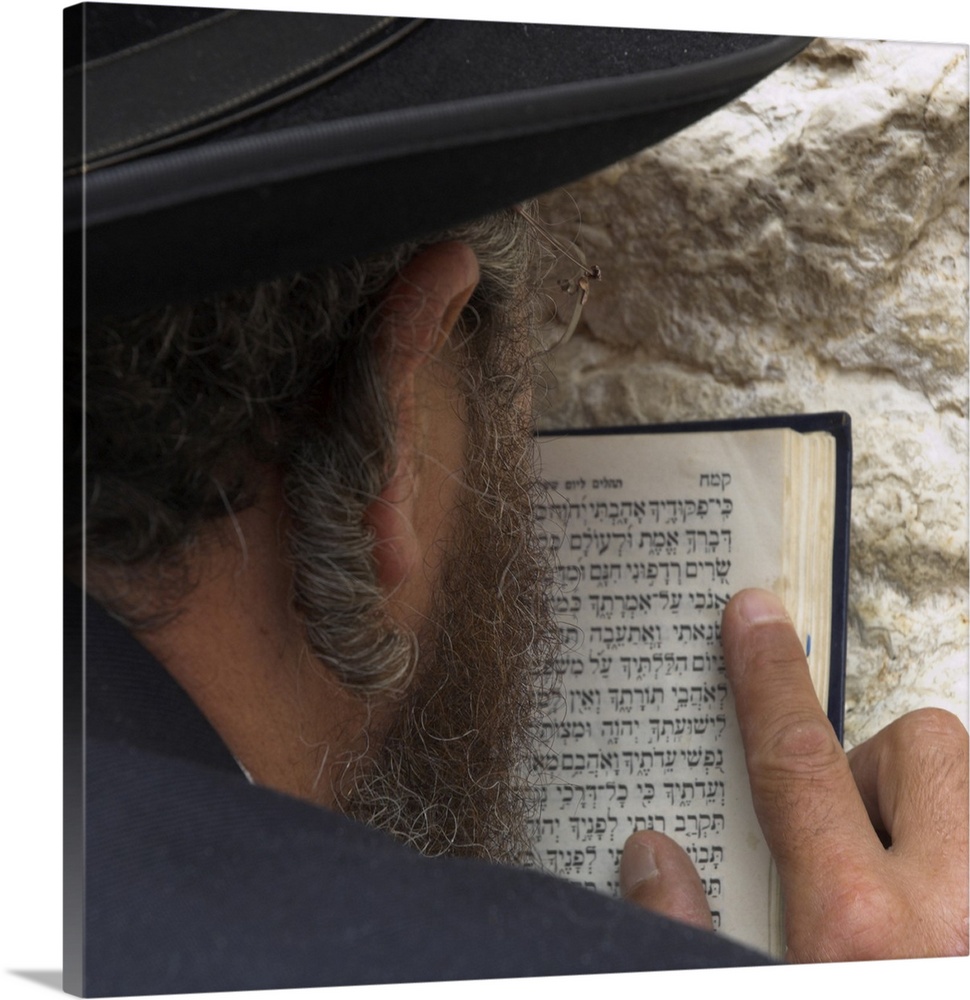 Close up of an Orthodox Jew holding prayer book against the wall and praying, Western Wall, Jerusalem, Israel, Middle East