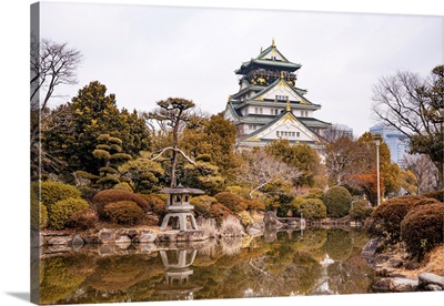 Osaka Castle In Japan Reflecting In A Pond Of A Japanese Castle