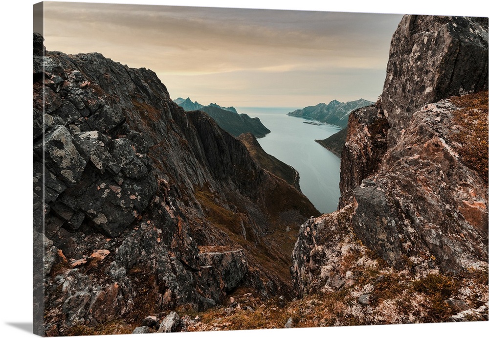 Oyfjorden fjord view from steep hiking trail through red rocks of mountains, Senja island, Troms county, Norway, Scandinav...