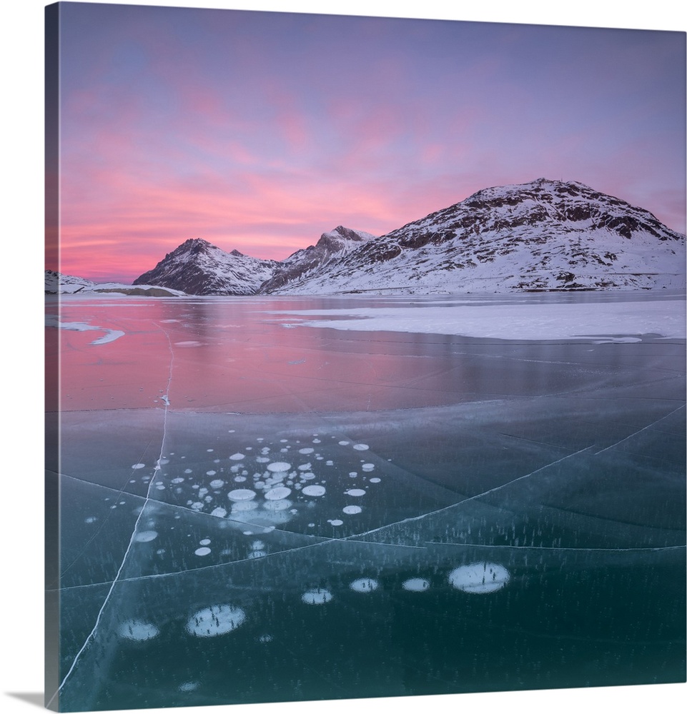 Panorama of ice bubbles and frozen surface of Lago Bianco at dawn, Bernina Pass, canton of Graubunden, Engadine, Switzerland