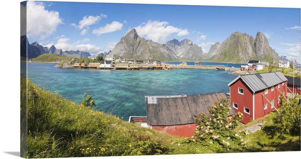 Panorama of turquoise sea and typical fishing village surrounded by rocky peaks, Sakrisoy, Reine, Moskenesoya, Lofoten Isl...