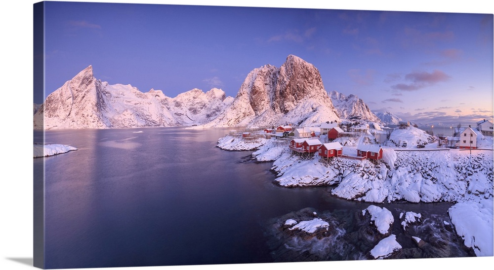 Panoramic view of snowy peaks and frozen sea at dawn around the fishing village, Hamnoy, Nordland, Lofoten Islands, Arctic...