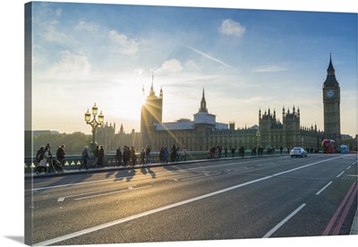 Pedestrians on Westminster Bridge with Houses of Parliament and Big Ben at sunset
