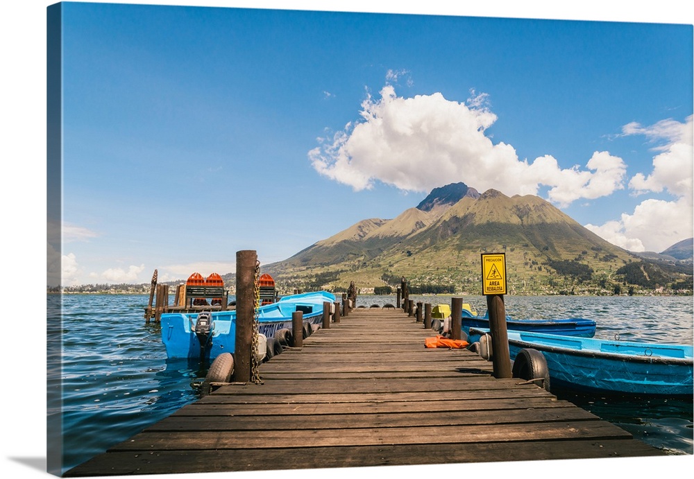 A pier and boat on Lago San Pablo, at the base of Volcan Imbabura, close to the famous market town of Otovalo, Ecuador