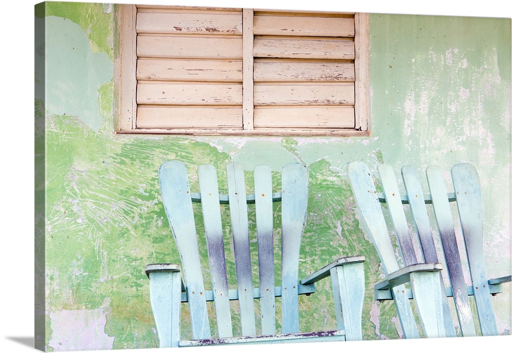 Detail of wall and rocking chair with faded paintwork in green and blue, a common sight in the small town of Vinales, Pina...