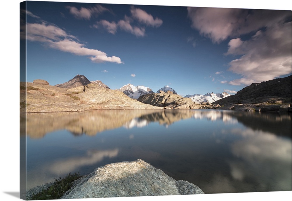 Pink clouds and peaks reflected in water at sunset, Fuorcla, Surlej, St. Moritz, Canton of Graubunden, Engadine, Switzerla...