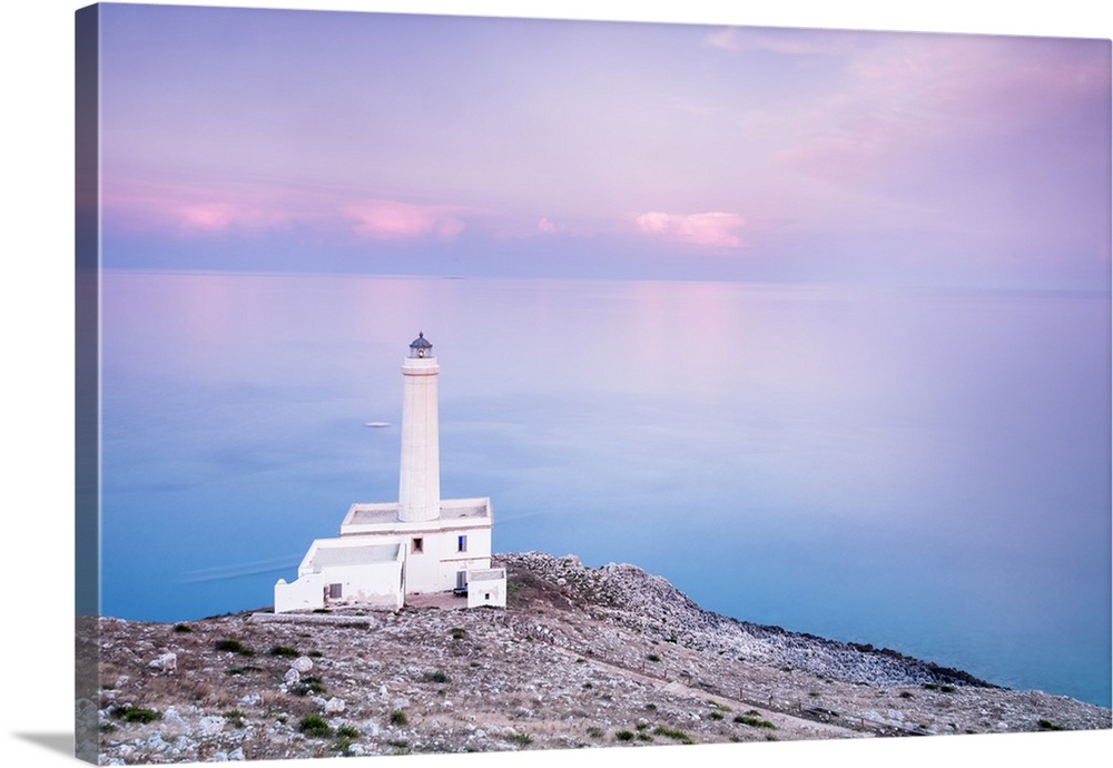 Pink sky on turquoise sea frames the lighthouse at Punta Palascia at sunset, Otranto, Province of Lecce, Apulia, Italy