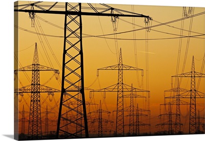 Pylons and power lines in morning light, Germany