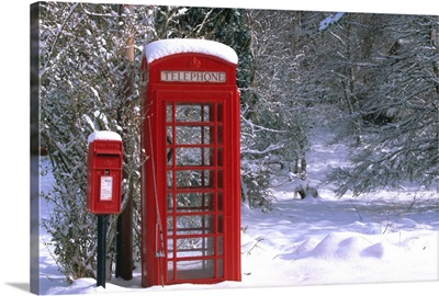 Red letterbox and telephone box in the snow, Highlands, Scotland, UK