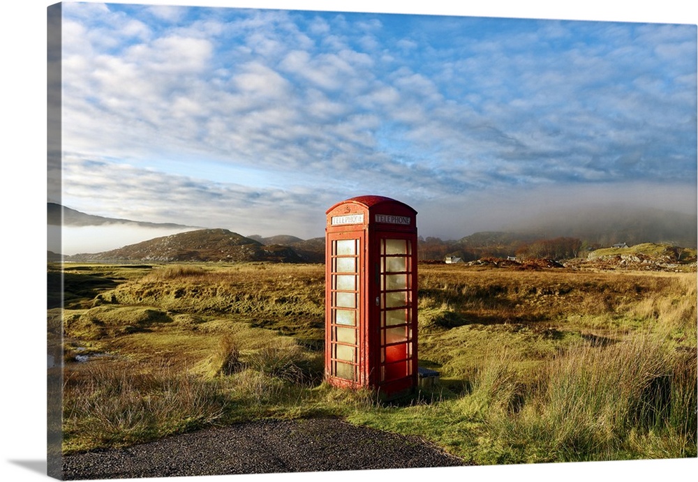 Autumn view of a red telephone box at the side of a quiet road in the remote misty Ardnamurchan moors of the Scottish High...