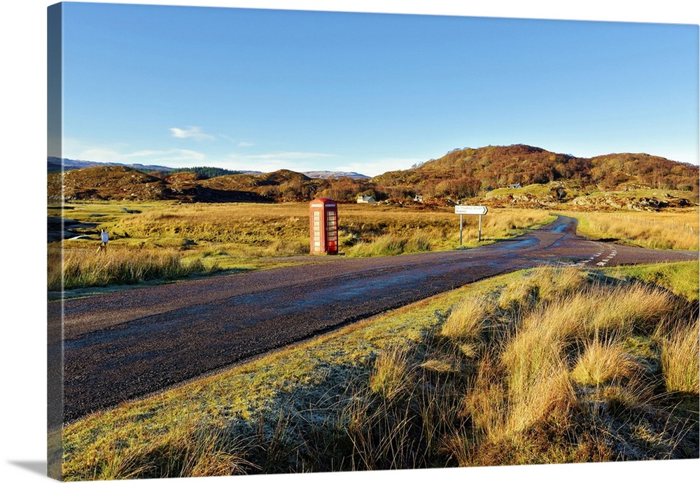 An autumn view of a red telephone box at the side of a quiet road in the remote Ardnamurchan moors of the Scottish Highlan...