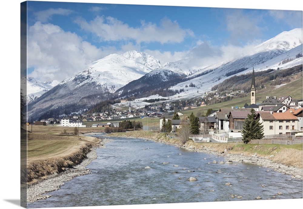 River Inn frames the alpine village of Zuoz surrounded by snowy peaks, Maloja, Canton of Graubunden, Engadine, Swiss Alps,...