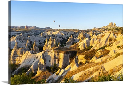 Rock Formations With Distant Views Of Uchisar Castle At Sunrise, Anatolia, Turkey