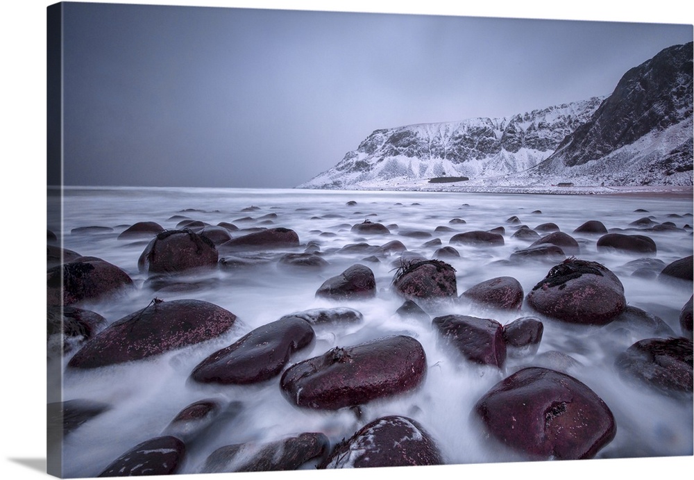 Rocks on the beach modeled by the wind surround the icy sea, Unstad, Lofoten Islands, Arctic, Norway, Scandinavia, Europe