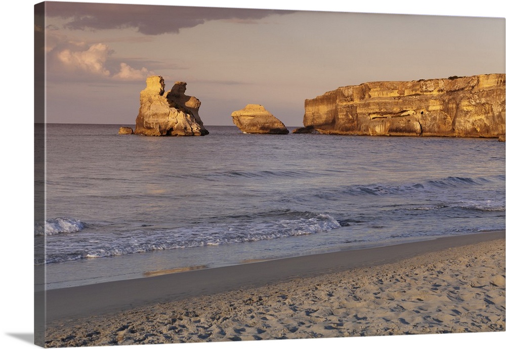 Rocky coast near Torre dell'Orso, Due Sorello Rocks (Two sisters) at sunset, Adriatic Sea, Lecce province, Salentine Penin...