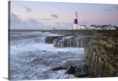 Rough seas crash over rocks near Portland Bill Lighthouse, Dorset, England
