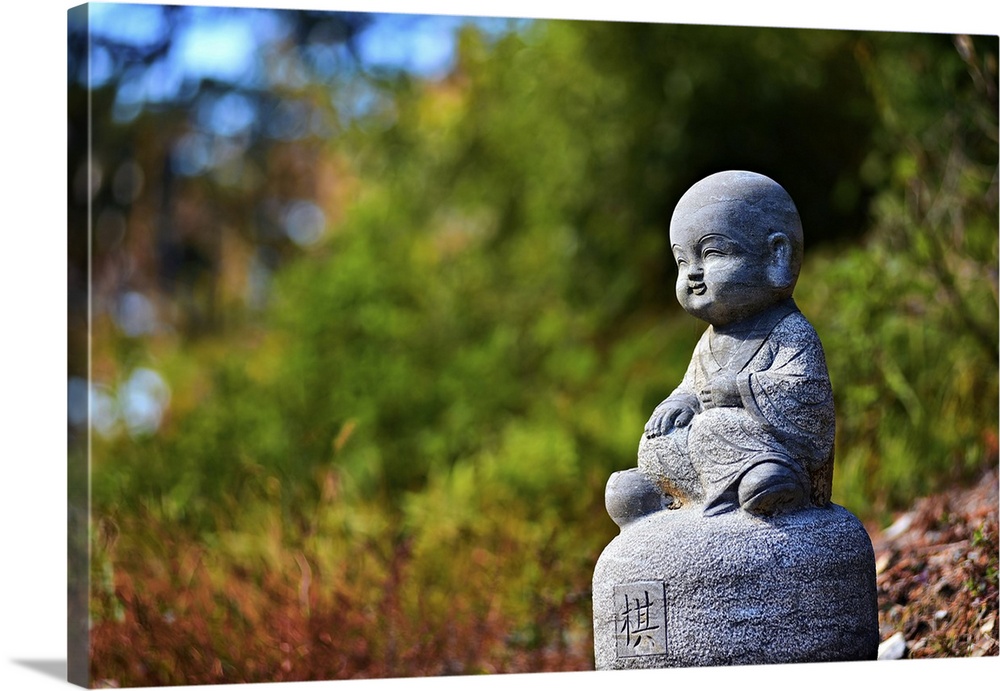 Adorable stone sculpture of a child monk in Nuona Pagoda Temple, aka Small Heavenly Pool Temple, a Tibetan Temple in Lusha...