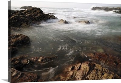 Sea swirling around rocks, near Polzeath, Cornwall, England, UK
