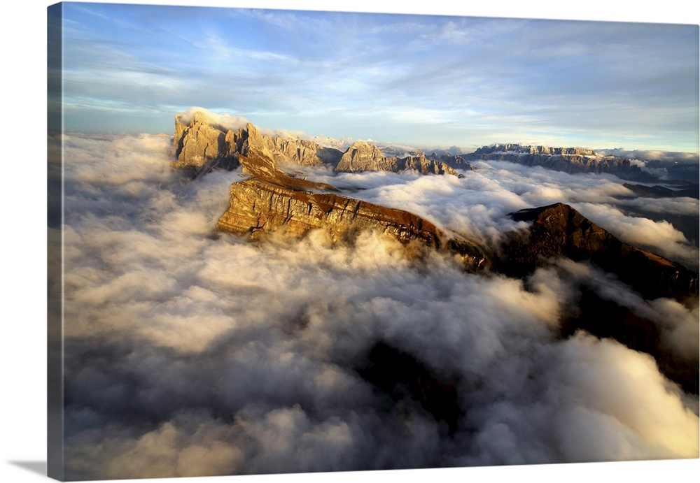 Aerial shot from Seceda of Odle surrounded by clouds at sunset in the Dolomites, Val Funes, Trentino-Alto Adige South Tyro...