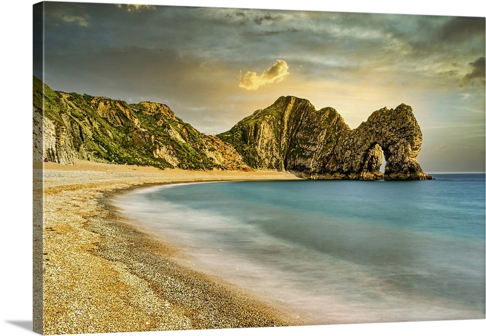 Serene beach with smooth waters, golden sand, and rugged cliffs under a sunset sky at Durdle Door, Jurassic Coast, UNESCO ...