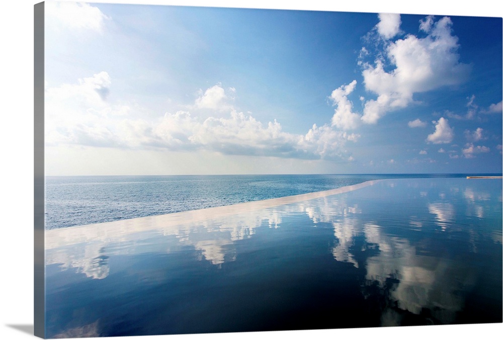 Infinity pool reflecting the sky and clouds with sea visible in the distance, Silavadee Pool Spa Resort, Koh Samui, Thaila...