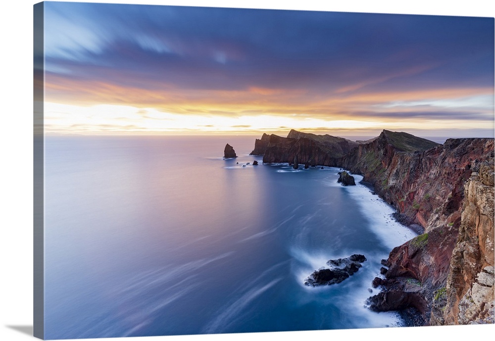 Dramatic sky at dawn on cliffs washed by ocean from Ponta Do Rosto viewpoint, Sao Lourenco Peninsula, Madeira, Portugal, A...