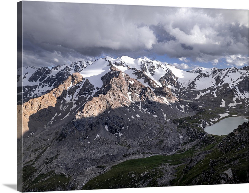 Snow-capped peaks and lush valleys at sunset showcased in a stunning landscape, Kyrgyzstan, Central Asia, Asia