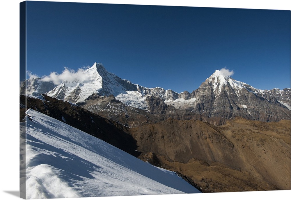 Snow on the Nyile La, a 4950m pass, and the peak of Jitchu Drake at 6714m in the distance, Bhutan, Himalayas