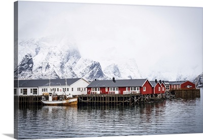 Snowcapped Mountains And Traditional Rorbu Cabins, Lofoten Islands, Norway