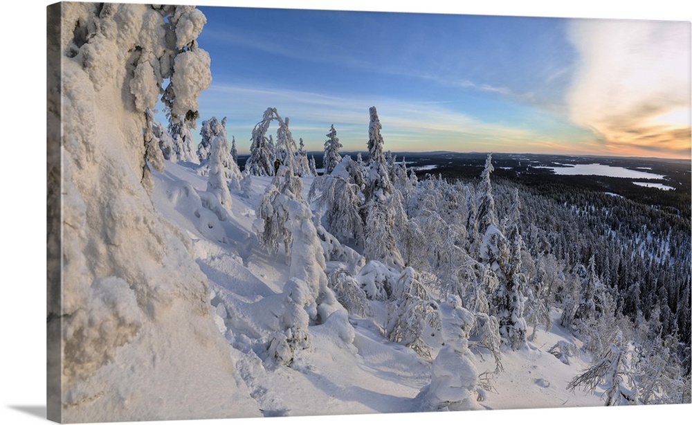 Panorama of snowy landscape and woods framed by blue sky and sun, Ruka, Kuusamo, Ostrobothnia region, Lapland, Finland