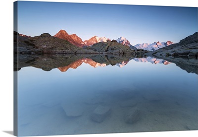 Snowy peaks reflected in the alpine lake at sunset, Fuorcla, Surlej, Switzerland